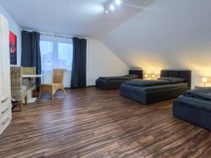 a large room with two beds and a desk at Alpha Apartments in Datteln