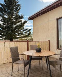 a wooden table and chairs on a deck at BSG Apartments in Selfoss +20 photos