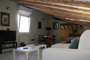 a living room with a white couch and tables at 18 Torres in Zaragoza