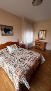 a bedroom with a bed with a colorful blanket on it at Casa Alfredo in Badarán