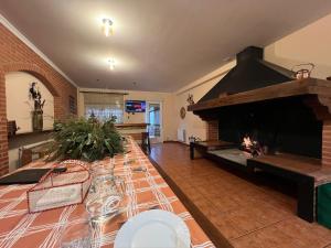 a living room with a table and a fireplace at Casa Alfredo in Badarán