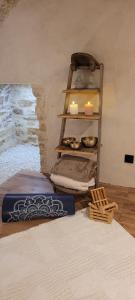 a room with candles and a shelf with food at A l'ombre des sentiers in Cuisiat