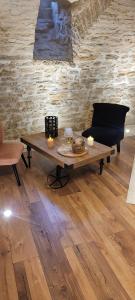 a living room with a table and a couch at A l'ombre des sentiers in Cuisiat