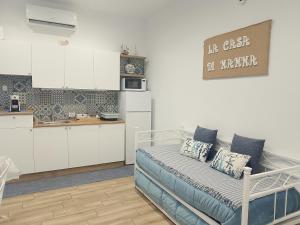 a kitchen with a bed in a room at La casa di mamma in Monopoli