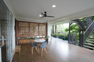 a room with a table and chairs and a staircase at Vine and Canopy in Olongapo
