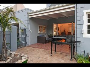 a outdoor patio with a grill with a fire at Sunflower Villa in Franschhoek in Franschhoek