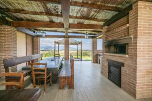a patio with a fireplace and a table and chairs at Villa degli Olivi in Crespina