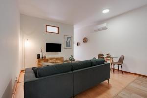 a living room with a couch and a table at Modern studio near Metro in Senhora da Hora