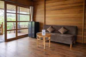 a living room with a couch and a table at Alam Bulangan Villa in Sukawati