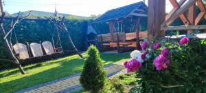 a garden with a gazebo and some flowers at Chata Venus in Bóbrka