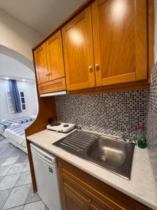 a kitchen with a sink and a bed in a room at Sea View Studios & Apartments in Agia Anna Naxos +70 photos