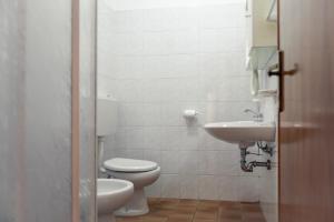 a bathroom with a toilet and a sink at Hotel Morandi in Valbondione