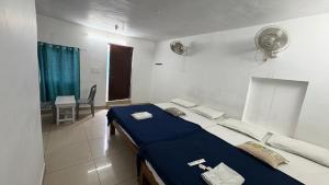 a bedroom with a blue bed in a room at Beach Times Resort in Kottakupam