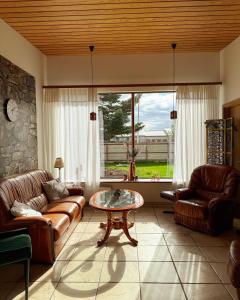 a living room with couches and a table and a window at BSG Apartments in Selfoss
