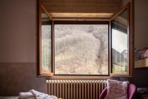 a window in a room with a radiator next to a window at Hotel Morandi in Valbondione
