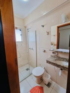 a bathroom with a shower and a toilet and a sink at Portal Palace Hotel in Aparecida +39 photos