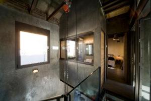 a staircase in a room with a window and a mirror at Retiro Park Industrial House in Madrid +90 photos