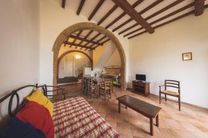 a living room with a couch and a table at Relais La Pieve Vecchia in Riparbella +67 photos