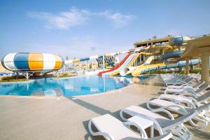 a water park with a water slide and chairs at Stella Beach Resort & Spa Makadi Bay - 24 HRS All Inclusive in Hurghada +193 photos