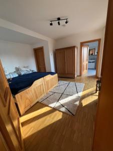 a bedroom with a bed with a blue comforter at Ferienwohnung Schwarzwald - Nähe der Schweiz in Hüfingen