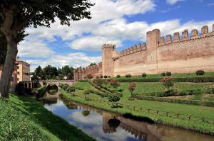 a large castle with a river in front of it at Hotel Filanda in Cittadella