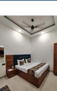 a bedroom with a bed with a ceiling at Aastha view inn in Amritsar