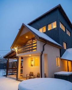 a house with snow on the roof at Villa J'adore in Crasna