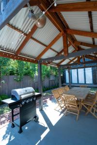 a patio with a grill and a table and chairs at Rosewood Terrace in Bathurst
