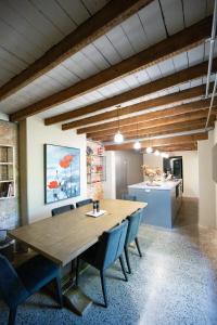 a dining room with a wooden table and blue chairs at Rosewood Terrace in Bathurst