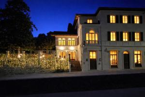 a house decorated with christmas lights at night at Villa Palazzo Delle Erbe in Casole dʼElsa