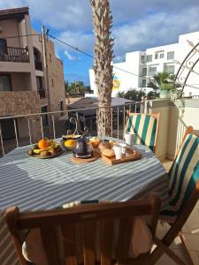 a table on a balcony with fruit on it at T2 Apart - Beach View - Santa Maria Center in Santa Maria