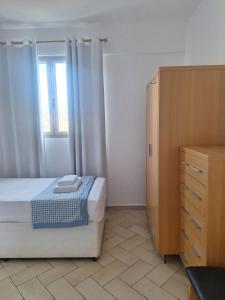 a bedroom with a bed and a dresser and a window at T2 Apart - Beach View - Santa Maria Center in Santa Maria +15 photos