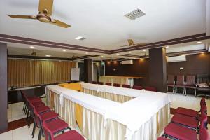 a conference room with red chairs and a long table at Bengal Inn in Kolkata +10 photos