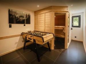 a room with a game table in the middle of it at Chalet L'Ursus - OVO Network in Gérardmer