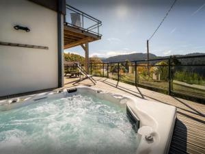 a hot tub on the deck of a house at Chalet L'Ursus - OVO Network in Gérardmer