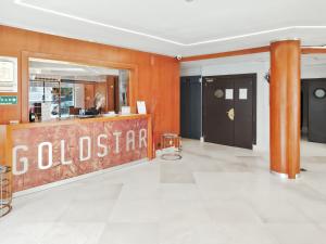 a store lobby with a sign that reads colustrian at Goldstar Resort & Suites in Nice