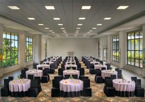 a banquet hall with tables and chairs in a room with windows at Gateway Goa, Palolem in Palolem +119 photos