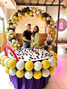 a man and woman standing in front of a large cake at "Earthy Couple Retreat Near Taj Mahal" Private Spa Jacuzzi in Agra