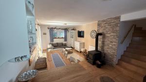 a living room with a couch and a fireplace at Chalupa ve Sněžném in Sněžné