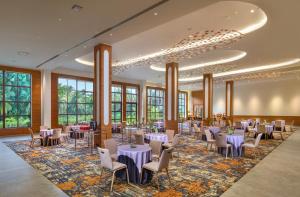 a banquet hall with tables and chairs and windows at Gateway Goa, Palolem in Palolem