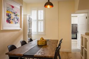 a dining room with a wooden table and chairs at Trevor Street in Holywood