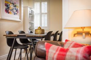 a living room with a table with chairs and a lamp at Trevor Street in Holywood