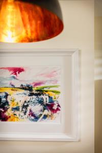 a painting in a white frame on a wall at Trevor Street in Holywood +15 photos