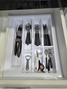 a white tray with utensils in a drawer at LOFT1304 Maxplaza Canoas in Canoas