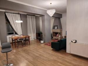 a living room with a table and chairs and a couch at Mikado lounge in Itʼkhvisi