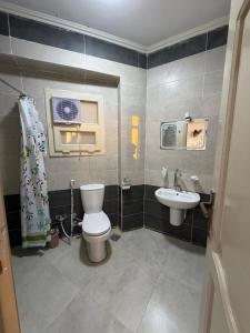 a bathroom with a toilet and a sink at Siwa Star Rooms in Siwa +93 photos