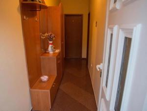 a hallway with a dresser and a mirror in a room at Apartmani OREBIĆ in Orebić +39 photos