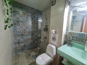 a bathroom with a toilet and a sink at Art House Plovdiv in Plovdiv +34 photos