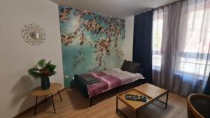 a small room with a bed and a table at Art House Plovdiv in Plovdiv