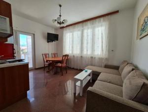 a living room with a couch and a table at Apartmani OREBIĆ in Orebić